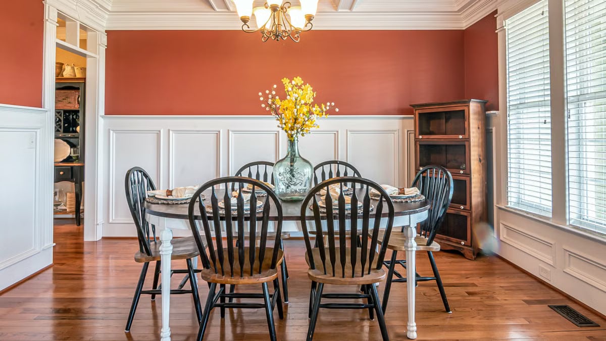 Bright and sophisticated dining room featuring a round table and elegant decor.